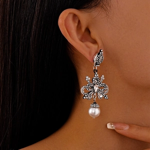 Baroque bow earrings with black rhinestones and large white pearls for women