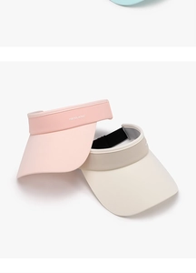 Detail of light pink and beige sun visors with wide brims and inner sweatband