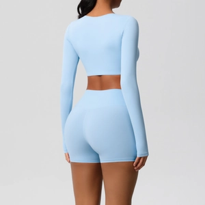 Rear view of a light blue long-sleeved crop top and high-waisted yoga shorts set