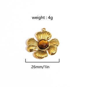 Detail of golden flower pendant with brown gemstone inlay showing 26mm size and 4g weight