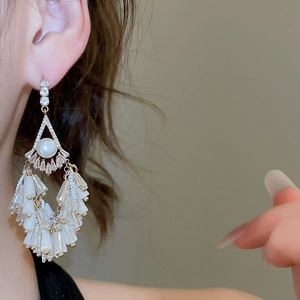 Detailed view of elegant silver needle pearl earrings with long crystal fringe tassels