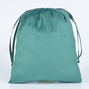 Close-up of green velvet drawstring pouch showing soft fabric texture and ribbon closure