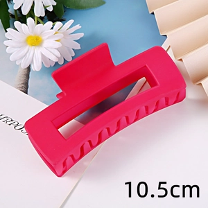 Detail shot of vibrant pink matte rectangular hair claw clip, displaying 10.5cm size clearly.