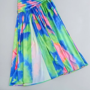 Detail of vibrant tie-dye pleated dress fabric featuring a stylish side slit design