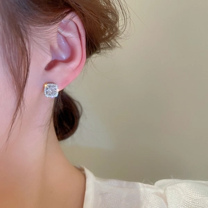 Detail showing square halo stud earrings with silver finish and sparkling cubic zirconia