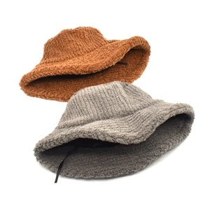 Winter faux shearling bucket hats in caramel and grey-blue with adjustable inner straps