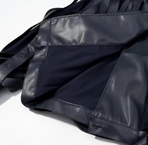 Detailed close-up of premium black PU leather jacket with metallic buttons and grommets