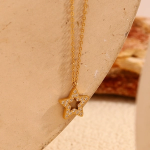 Macro view of 18K gold plated star pendant necklace featuring sparkling zircon stones
