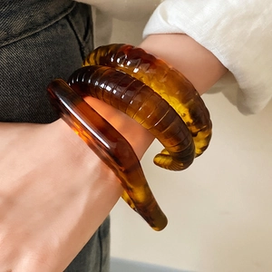 Maillard amber resin bangle set with smooth and twisted textures for women