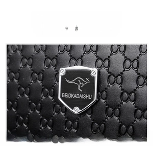 Macro shot of premium first layer cowhide with embossed pattern and metal logo plate