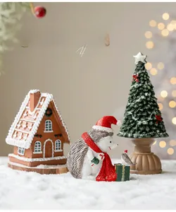 Miniature Christmas resin set with gingerbread house, hedgehog, and tree in a snowy scene