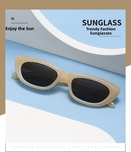 Detailansicht der cremefarbenen Cat-Eye-Polarisationsbrille mit dunkelgrauen Gläsern