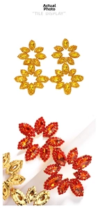 Detail of oversized floral drop earrings with marquise-cut yellow and red crystals