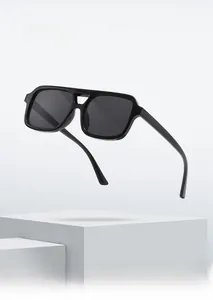 Floating black square sunglasses with thick frames on white geometric steps display