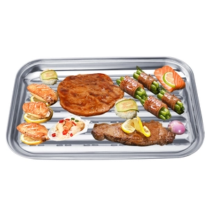 Stainless steel square BBQ grill pan with oil drainage grooves and grilled meats