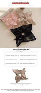 Detailed view of organza scrunchies with lace trim, pearls, and small metal bows