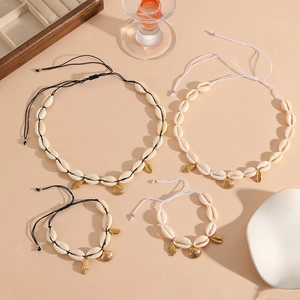 Natural seashell jewelry set with starfish pendants, gold charms, and woven necklaces