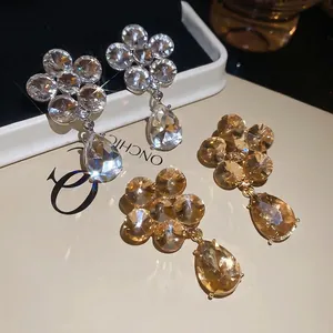 Sparkling floral waterdrop earrings in silver and gold plating with crystal pendants