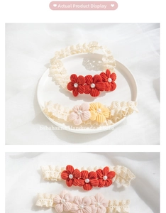 Close-up of handmade lace baby headband with corduroy flowers and pearl centers