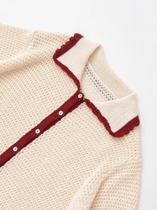 Close-up of knit hollow-out polo cardigan collar with contrast trim and small buttons