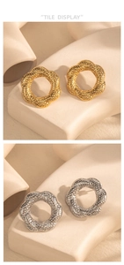 Detail of flower-shaped textured stud earrings in gold and silver finish