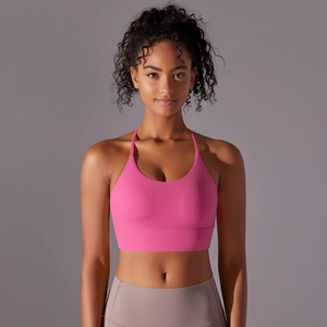 Close-up of bright rose pink sports bra with cross-back straps and high-elastic fabric