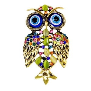 Luxurious owl brooch with colorful rhinestones and blue evil eye detail on white background