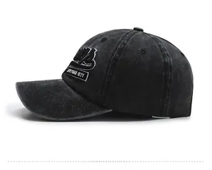 Detailed side view of washed black denim baseball cap with New York City embroidery