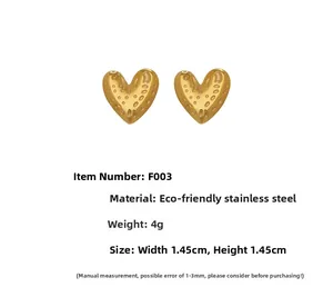 Detailed view of golden heart studs with hammer texture, 1.45cm stainless steel earrings