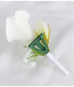 Detailed back view of white calla lily boutonniere with metal pin and green plastic base