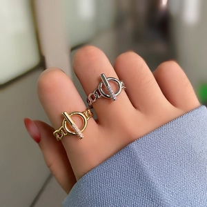 Detail of gold and silver Cuban link rings with T-bar pavé crystal setting