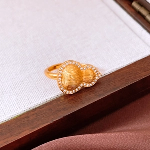 Macro detail of gold gourd ring featuring brushed texture and micro-set pavé crystals