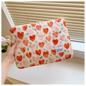 Quilted heart pattern laptop sleeve with Hello Everything Good Luck label detail