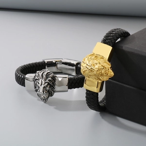 Macro detail of braided leather bracelets with gold and silver lion head metal clasps