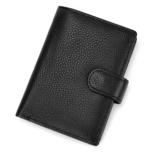 Close-up of black lychee grain leather wallet with classic snap button closure