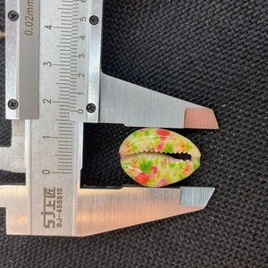 Macro view of 1.8cm floral pattern shell bead length measurement using a caliper