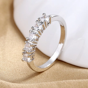 Macro shot of silver ring with five micro-set round cubic zirconia stones