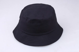 Detailed top view of a black cotton bucket hat showing fabric texture and wide brim