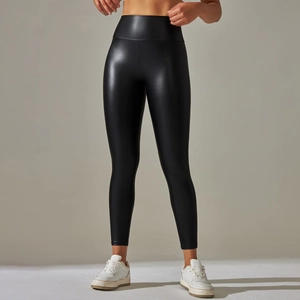 Close-up of high-waisted black faux leather leggings with glossy metallic finish
