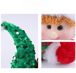 Detail of Christmas elf dolls with sequined hats and orange hair texture closeup