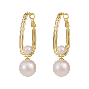 Elegant gold geometric U-shaped earrings with faux pearl accents on a white background