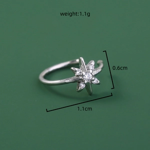 Macro shot of silver star nose ring with dimensions 1.1cm by 0.6cm and 1.1g weight