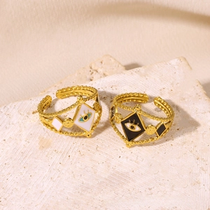 Close-up of vintage angel eye rings with colorful enamel on textured stone
