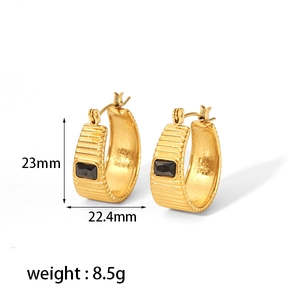 Detail of 18K gold plated hoop earrings with ribbed texture and square black zircon