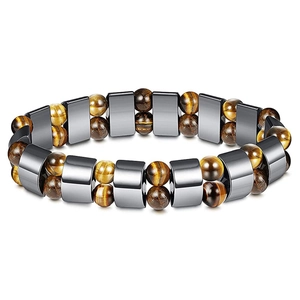 Macro view of elastic bracelet with tiger eye beads and polished dark gray magnetic spacers