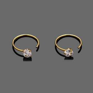 Macro shot of gold-plated stainless steel earrings with sparkling round zirconia details