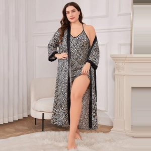 Women's plus size leopard print satin bathrobe and nightgown set in a cozy home setting