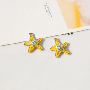 Detailed macro view of starfish charms with yellow enamel and crystal rhinestones