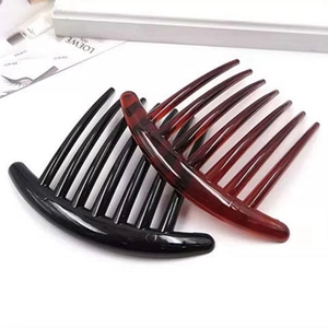 Detail of minimalist hair combs in black and tortoise shell finish for French styling