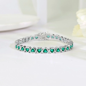 Macro detail of high-quality heart-shaped green zircon stones on silver plated tennis bracelet